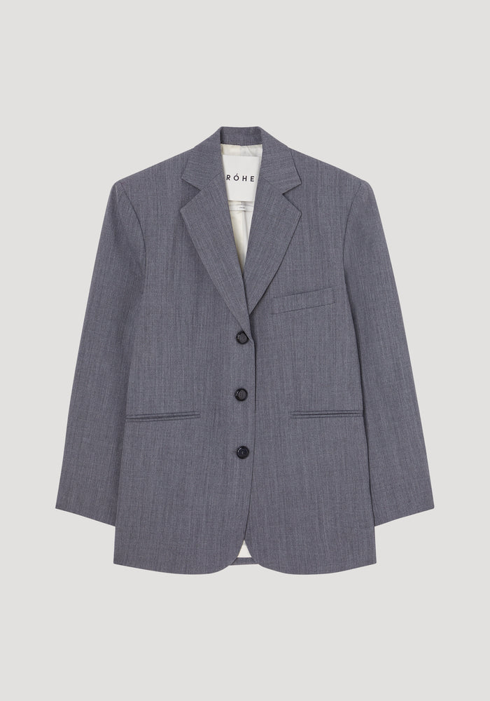Oversized blazer | grey melange, featuring notched lapels, three-button front, welt pockets, and white lining. Made from a wool-blend fabric by Italian mill Bisentino.