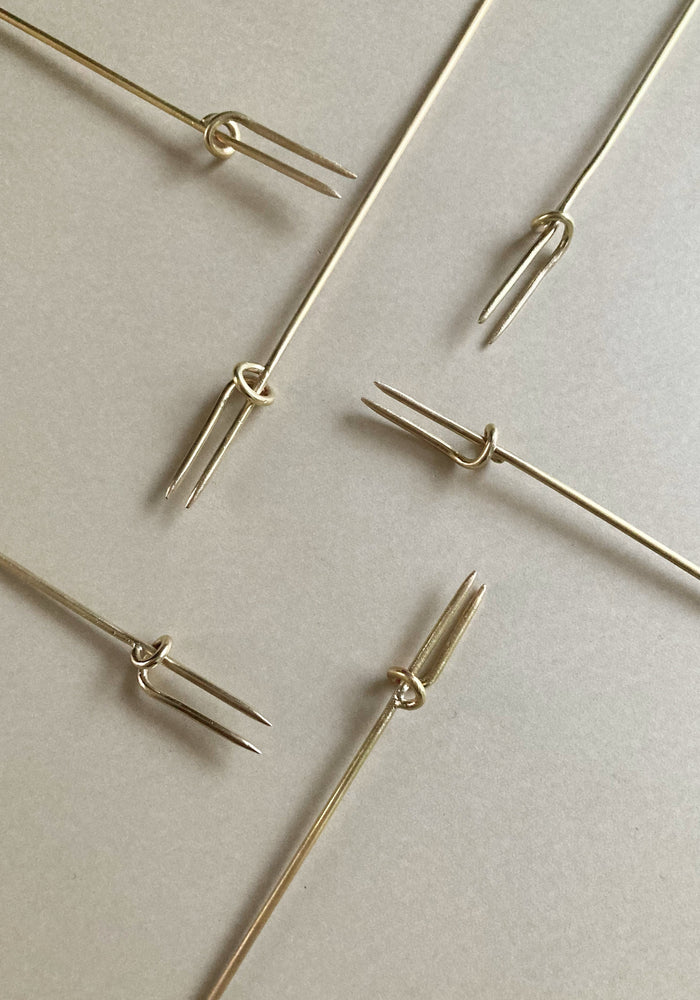 Vine Fork: Handcrafted gold-tone metal skewers with two prongs and a sliding ring, designed by Kyoto artist Nikke Misae for securing appetizers.