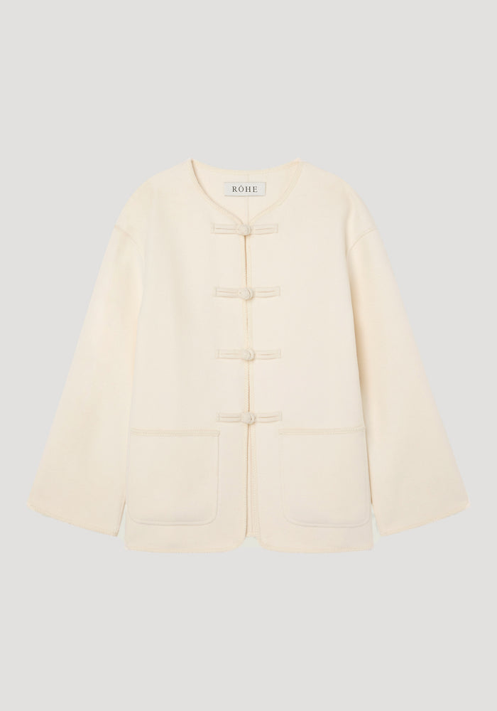 Double-faced wool pankou jacket in off white, features a round collar, pankou closures, embroidered edges, and patch pockets, made from 100% wool.
