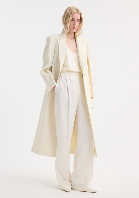 Signature opera coat | ivory: Long, single-breasted coat with a shawl collar, single button, mid-calf length, horizontal pockets, and center back slit. Elegant structured silhouette.