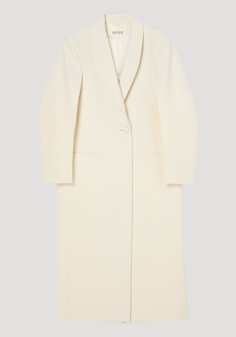 Signature opera coat | ivory: Long, single-breasted coat with a shawl collar, single button, mid-calf length, horizontal pockets, and center back slit. Elegant structured silhouette.