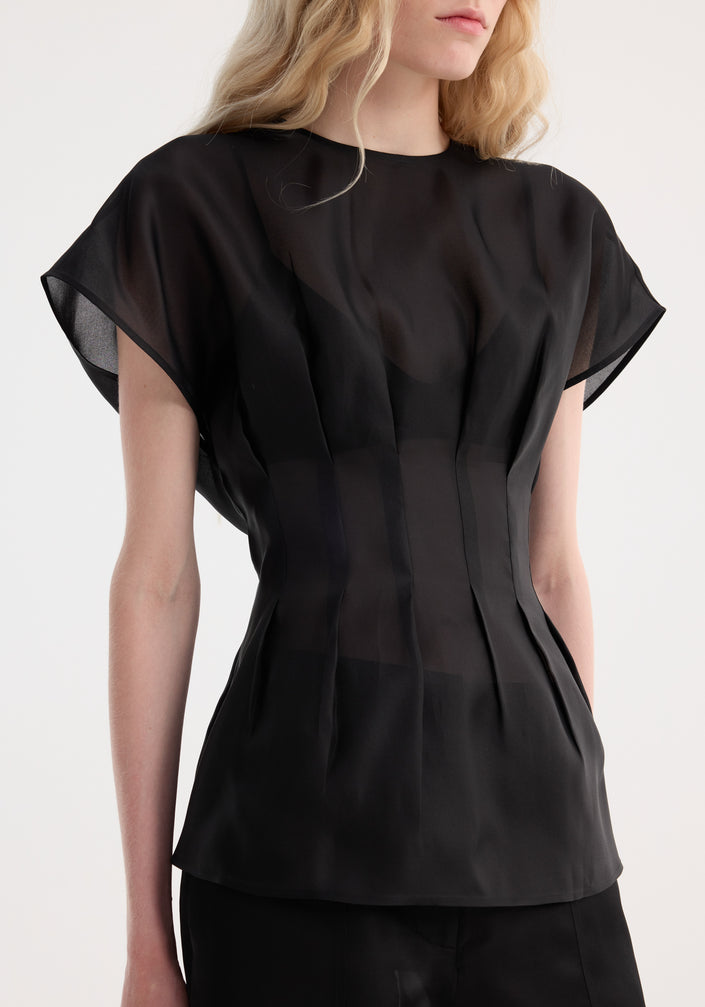 Model in Pleated Waistline Organza Silk Top, black, showcasing flutter sleeves, round neckline, cinched waist, and wide-leg trousers, all in sheer silk fabric.
