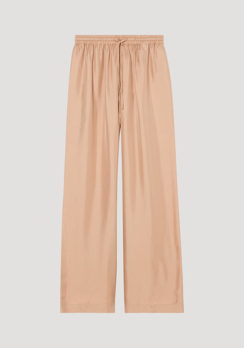 Wide leg silk trousers in soft beige, featuring an elasticated drawstring waistband and twill structure, designed with extra length for alterations.