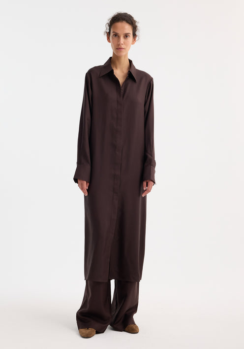 Model wearing Silk open back wrap dress | mahogany, button-down, collared, with wide-leg trousers and brown suede loafers; features keyhole back and wrap tie detail.