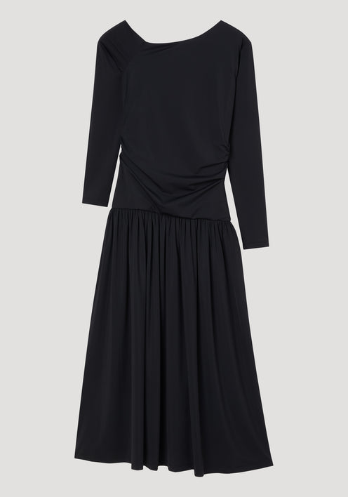 Asymmetrical jersey dress | black with long sleeves, fitted bodice, gathered waist, and a flowing mid-calf skirt, featuring an asymmetric neckline over one shoulder.