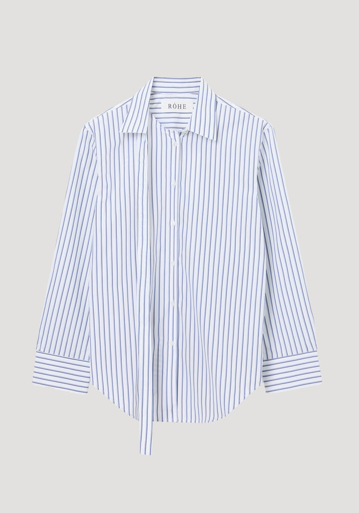Deconstructed striped shirt featuring a white and navy pinstripe pattern, classic collar with deconstructed detailing, button cuffs, and a slightly curved hem.