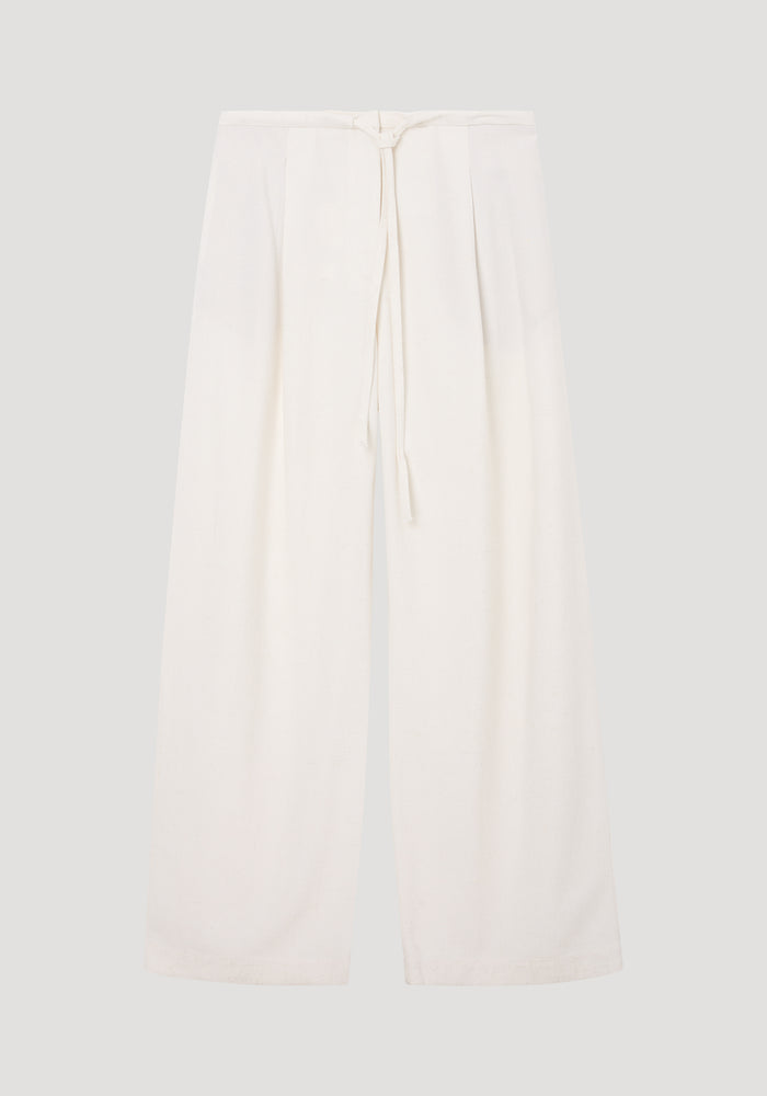 Relaxed drawstring trousers in winter white, featuring a wide-leg silhouette and a drawstring waistband, crafted from a soft silk blend fabric for comfort.