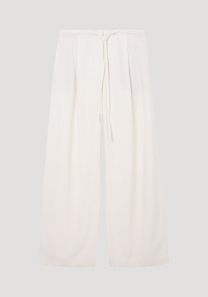 Relaxed drawstring trousers in winter white, featuring a wide-leg silhouette and a drawstring waistband, crafted from a soft silk blend fabric for comfort.