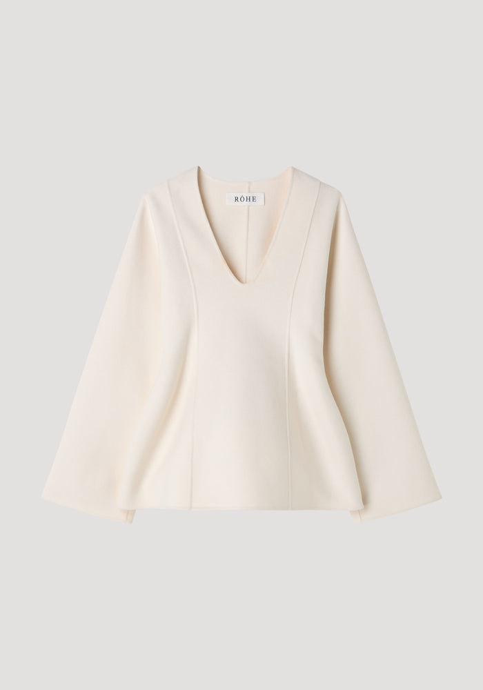 Sculptural long sleeve top | off white, featuring a deep V-neck, subtly flared sleeves, and an A-line silhouette with a small RÓHE label visible.