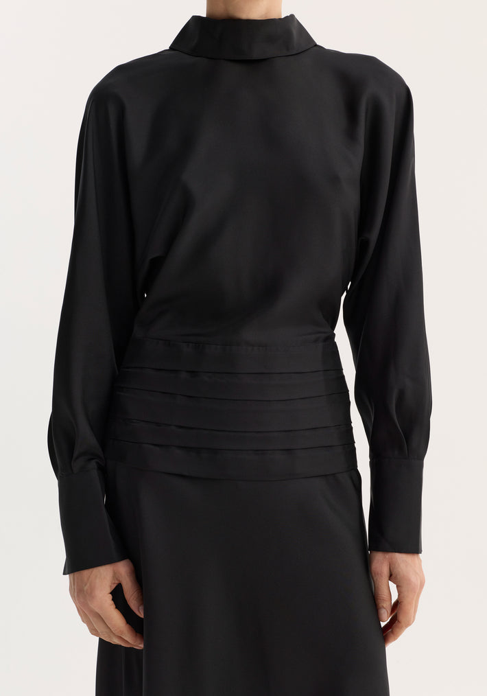 Tuxedo silk dress | black showcases a high-neck design with flowing sleeves, cummerbund pleats, and an open back, creating an elegant and minimalist silhouette.