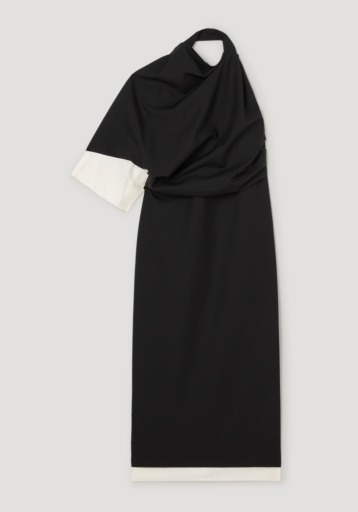 Draped open back dress in black with one-shoulder neckline, short sleeve, white-lined hem, and back slit, crafted from wool, polyester, and silk blend.