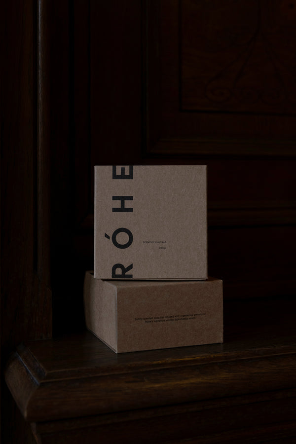 Stacked kraft boxes marked RÓHE, showcasing Diplomatico Soap | mist, a woody-scented bar with eco-certified coconut oil for soft, nourished skin.