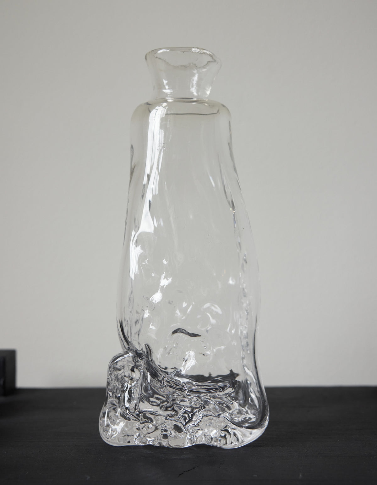 Blown vase | Glass: A unique, hand-blown clear glass vessel with an organic base, tapering into a narrow neck and flared mouth, crafted by Szkło Studio.
