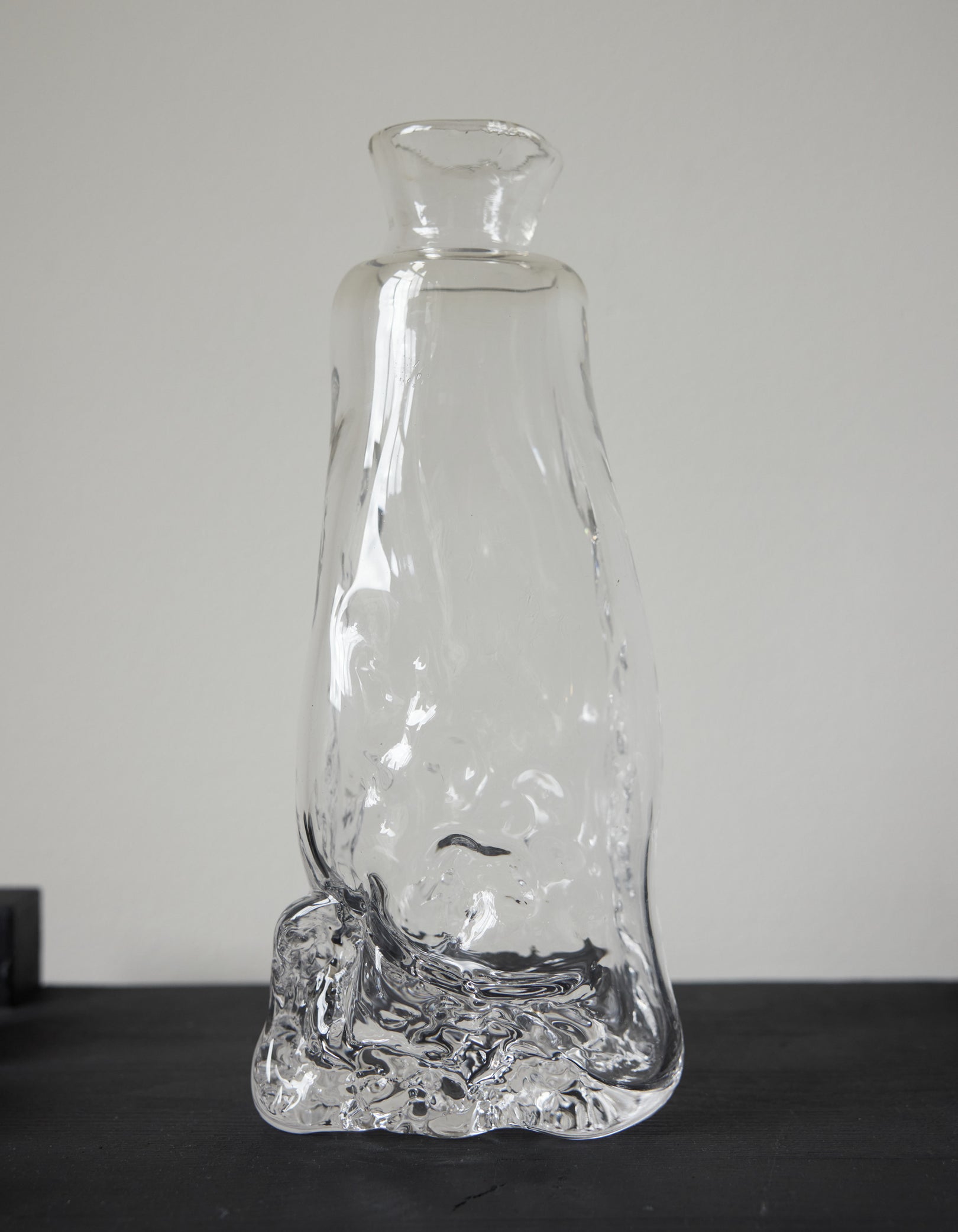 Blown vase | Glass: A unique, hand-blown clear glass vessel with an organic base, tapering into a narrow neck and flared mouth, crafted by Szkło Studio.