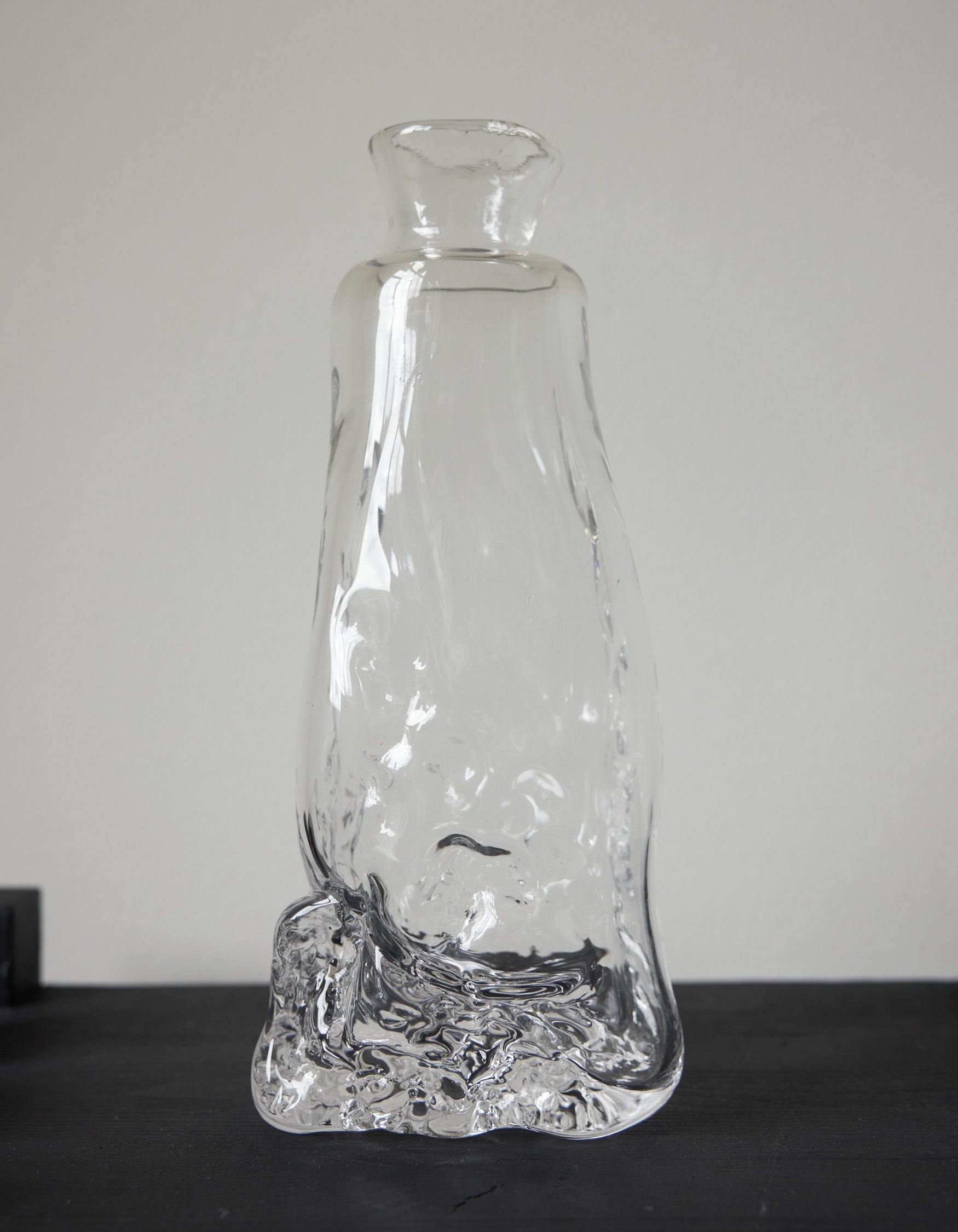 Blown vase | Glass: A unique, hand-blown clear glass vessel with an organic base, tapering into a narrow neck and flared mouth, crafted by Szkło Studio.