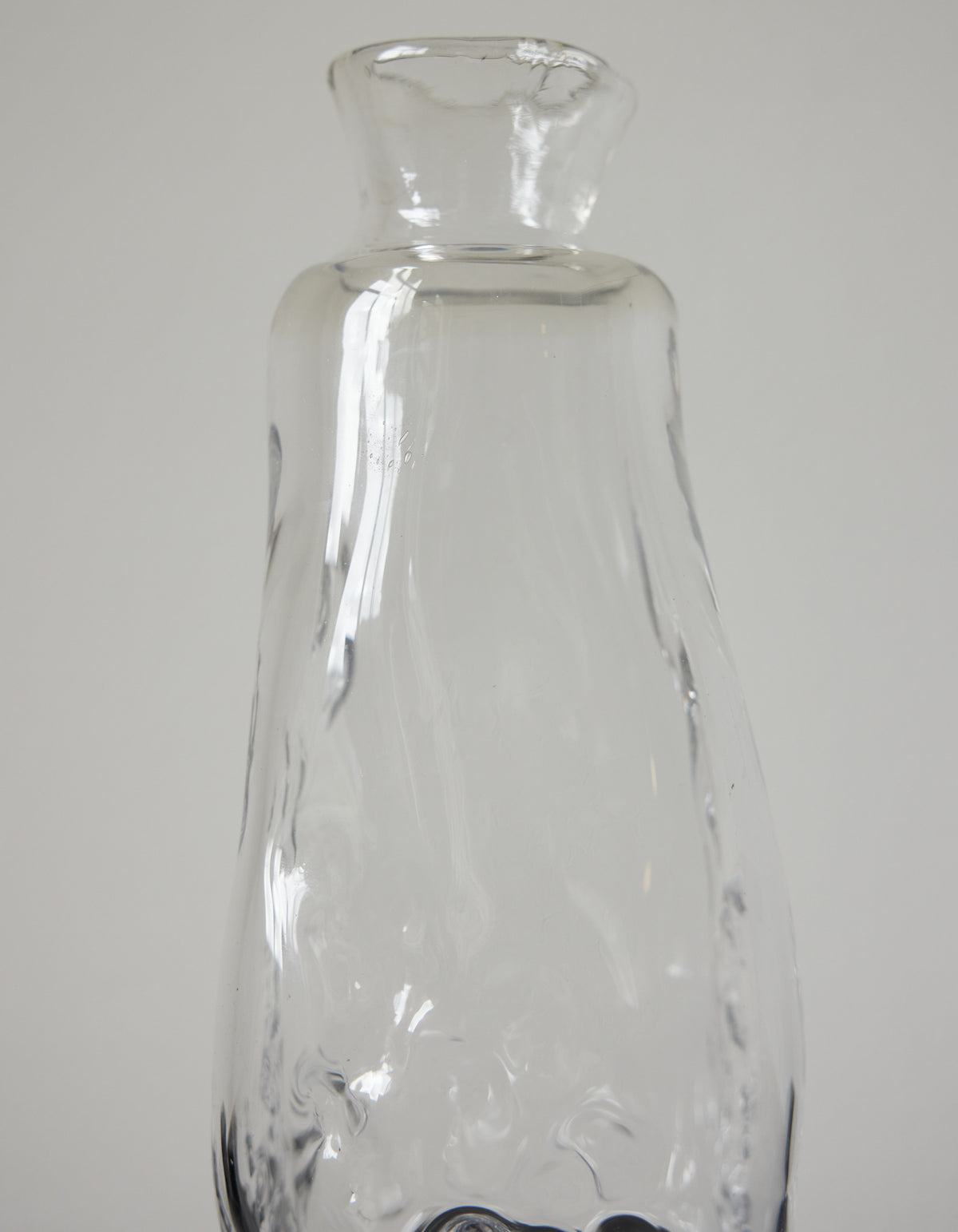 Blown vase | Glass: A clear, narrow-necked glass vessel with a slightly wavy texture, exemplifying Szkło Studio's handcrafted, unique design approach.