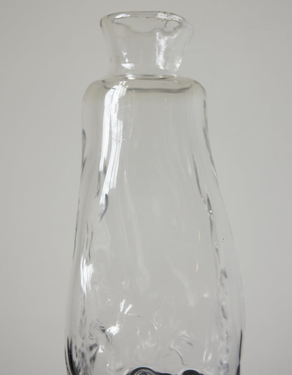 Blown vase | Glass: A clear, narrow-necked glass vessel with a slightly wavy texture, exemplifying Szkło Studio's handcrafted, unique design approach.