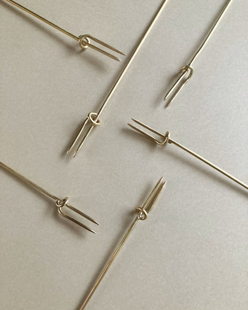 Vine Fork: Handcrafted gold-tone metal skewers with two prongs and a sliding ring, designed by Kyoto artist Nikke Misae for securing appetizers.