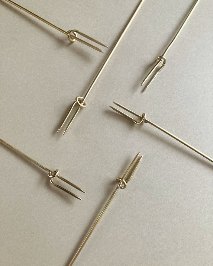 Vine Fork: Handcrafted gold-tone metal skewers with two prongs and a sliding ring, designed by Kyoto artist Nikke Misae for securing appetizers.