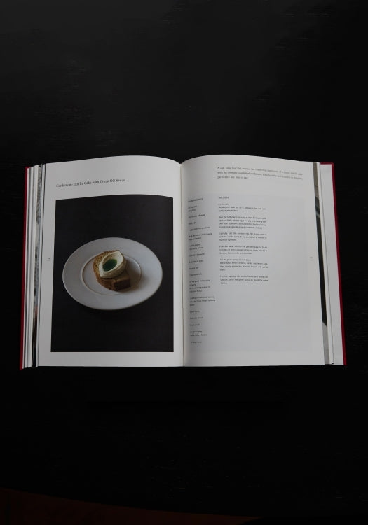 Róhe Cookbook | red, open to a recipe for Carbonara Rillette Cake with Green Olive Sauce, featuring a styled food photo and recipe text on adjacent pages.