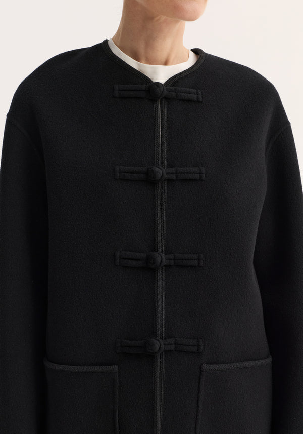 Mandarin double-faced wool jacket | black, featuring a round neckline, three-quarter sleeves, embroidered edges, pankou closures, and patch pockets, worn by a model.