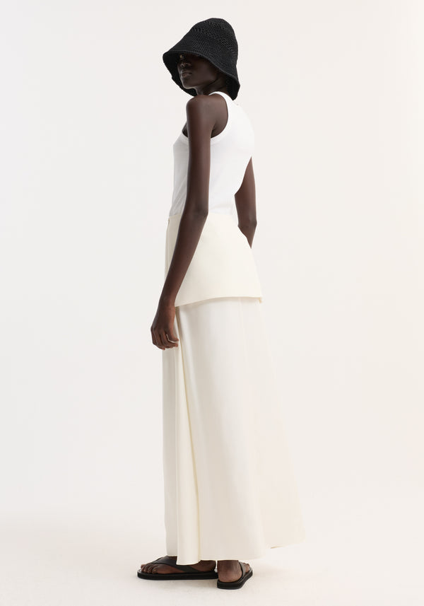 Model wearing Integrated fluid silk skirt | cream, featuring a high waist with layered waistband, blind side seam zip, and contrasting fused wool-silk textures.
