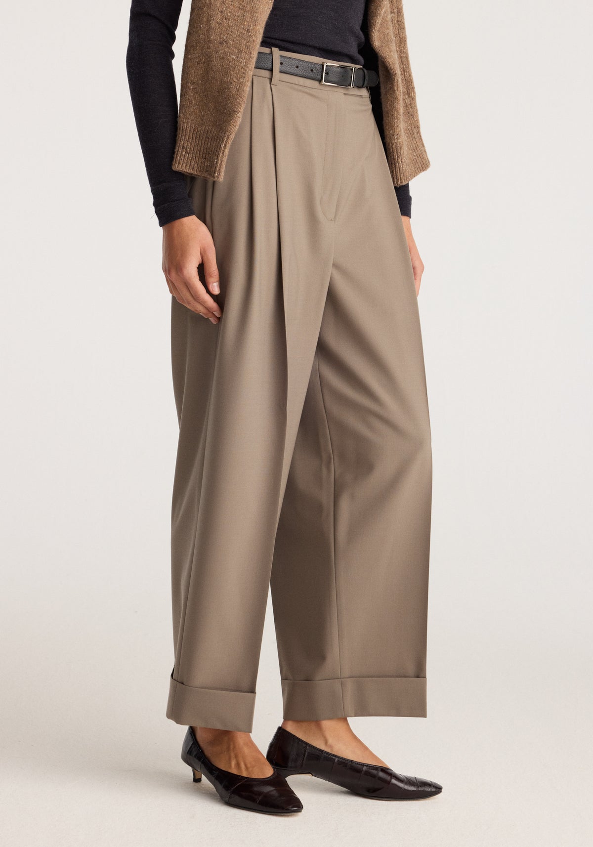 High-waist turn-up trousers | taupe shown on a model with wide legs, cuffed hems, pleats, a belt and black loafers