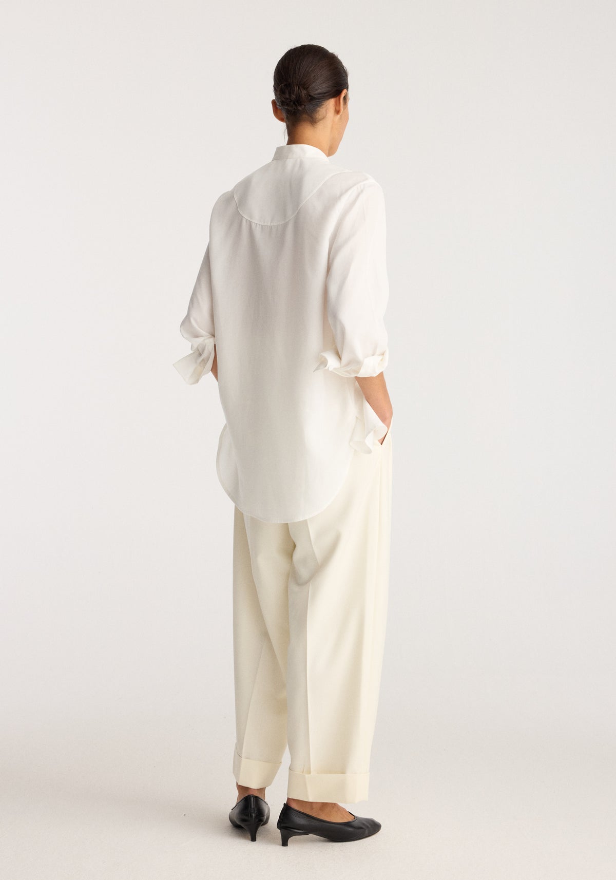 Tuxedo shirt | optic white shown from the back on a model, featuring long sleeves, a relaxed fit, curved hem, and crisp white fabric