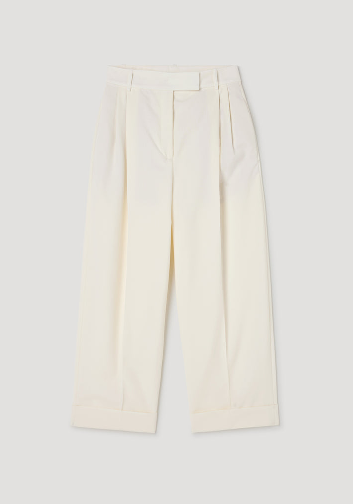 High-waist turn up trousers | off white laid flat, featuring a pleated front, wide legs, belt loops, and a cuffed hem for a classic tailored look.