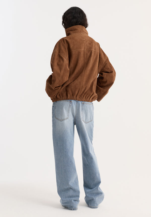 Reinvented suede jacket | cognac shown from behind, featuring a high stand-up collar, elasticized hem, and relaxed fit over light-wash blue jeans.