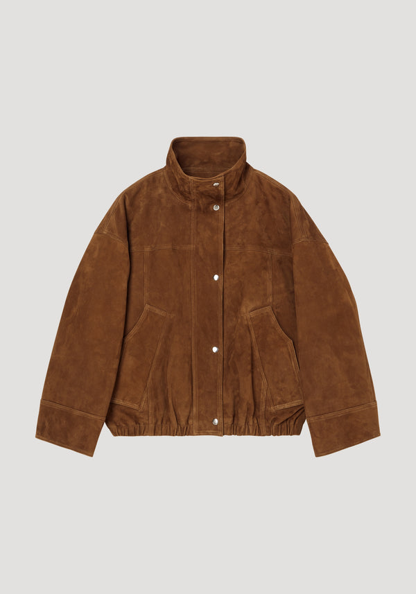 Reinvented suede jacket | cognac with a stand-up collar, snap buttons, two patch pockets, elasticized hem, wide cuffs, and relaxed, oversized fit.