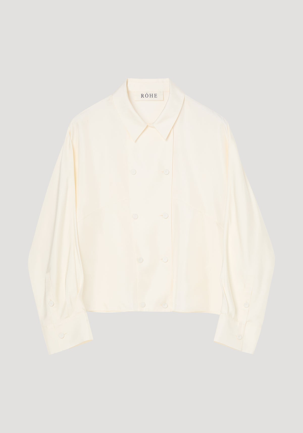 Double breasted silk top | cream, cream long sleeve collared blouse with double breasted button front on a light gray background