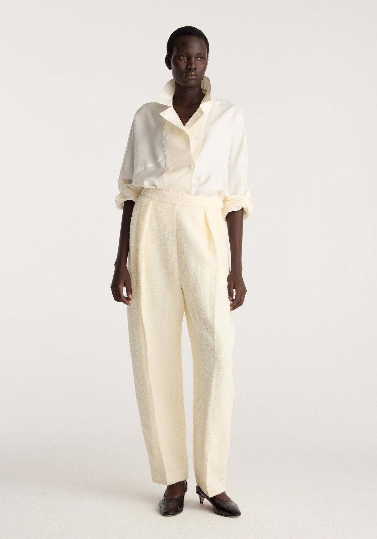 Puck - Sculptural bouclé tailored trousers | cream shown on a model with a high waist straight leg fit and soft textured finish