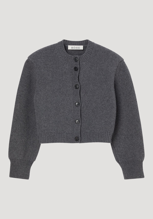 Statement shoulder cardigan in mid grey melange, featuring ribbed-knit texture, crew neckline, wide cuffs, black button closure, oversized fit with structured shoulders, woven label at back neck.