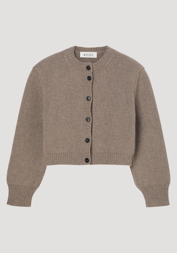 Statement shoulder cardigan in clay melange, showcasing a taupe rib-knit texture, structured shoulders, oversized fit, and dark button row closure; crafted from pure Italian wool.