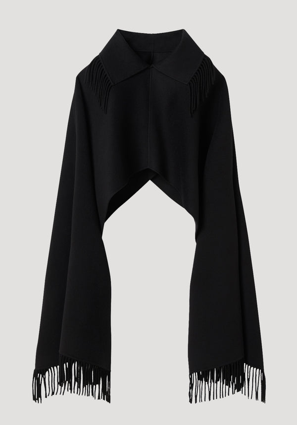Fringe poncho double-faced wool | black, featuring a pointed collar and long fringed edges, drapes elegantly as a refined, sculptural layering piece.