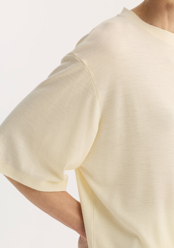 Close-up of an oversized merino T-shirt in a relaxed fit, showcasing elbow-length sleeves and dropped shoulders, highlighting its luxurious drape.