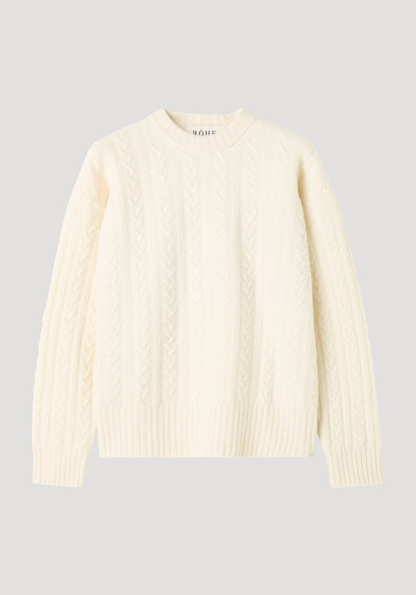 Cable knit jumper in off white, featuring an oversized fit with dropped shoulders and a round neckline, crafted from textured pure wool.