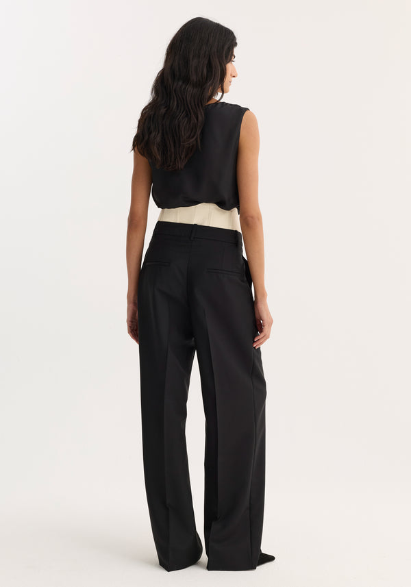 Model wearing Corset trousers | black, featuring high-waisted, wide-leg design with a cream corset belt. Tailored from lightweight wool-mohair blend for structure and breathability.