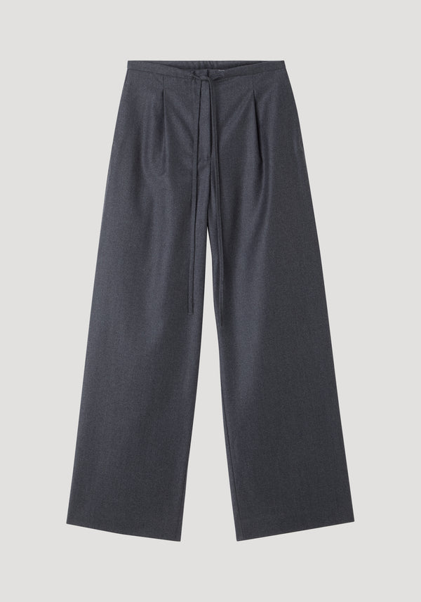 Relaxed soft wool trousers in dark grey melange featuring wide-leg design, high waist with drawstring, and subtle front pleats, crafted from lightweight virgin wool.
