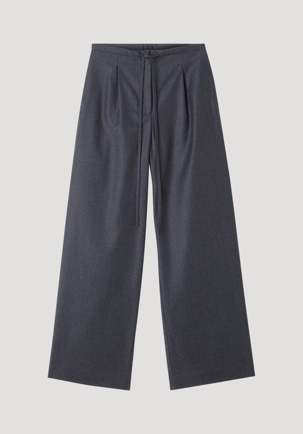 Relaxed soft wool trousers in dark grey melange, featuring a wide-leg silhouette, high waist with pleats, and a drawstring waistband for comfort.