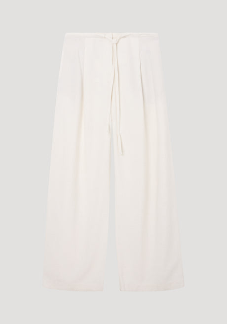 Relaxed drawstring trousers in winter white, featuring a wide-leg silhouette and a drawstring waistband, crafted from a soft silk blend fabric for comfort.