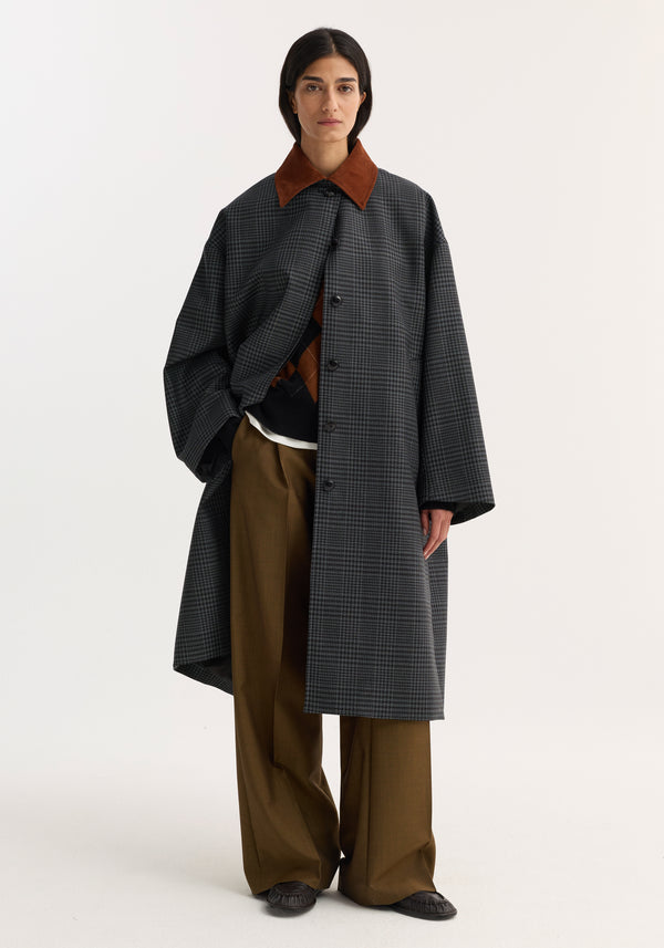 Suede collar check coat in dark gray with rust accents, oversized fit, wide-leg trousers, moc-style shoes, highlighting the coat's relaxed, structured design.