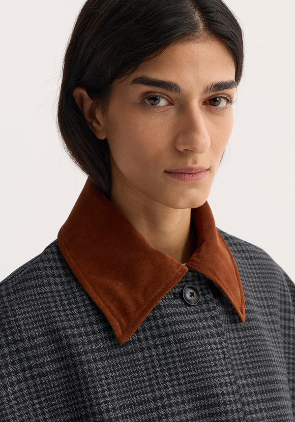 Woman wearing Suede Collar Check Coat in gray/black check pattern, featuring a rust-brown suede collar and visible dark button. Tailored, oversized fit with slant pockets.