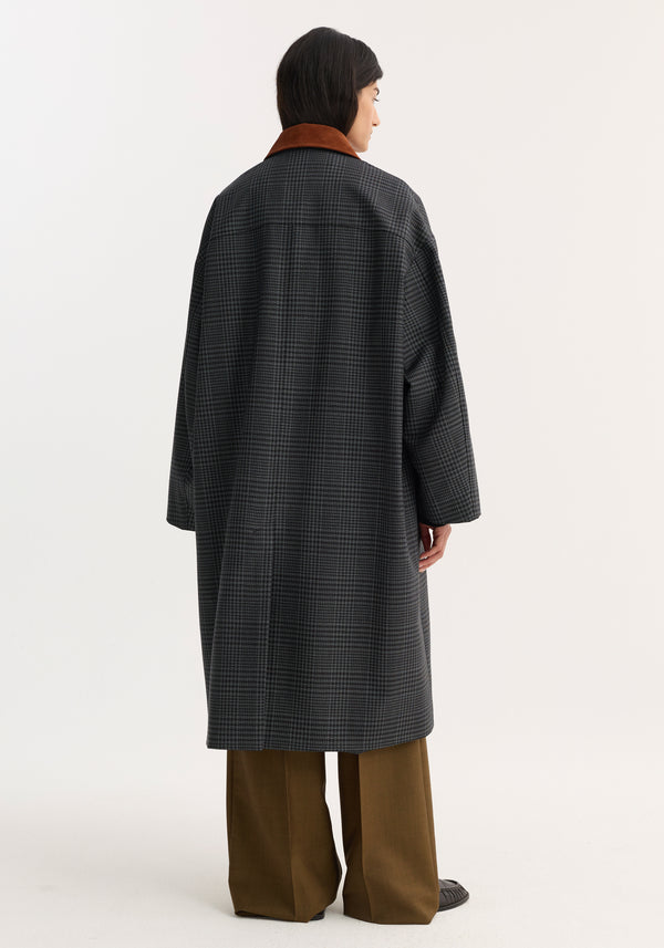 Person models a Suede Collar Check Coat with a gray check pattern, rust-brown collar, slant pockets, and wide-leg trousers against a plain backdrop.