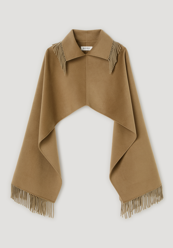 Fringe scarf poncho in camel-tan wool-cashmere, featuring a classic shirt collar, long fringed edges, and a draped, elegant silhouette with RÓHE label.