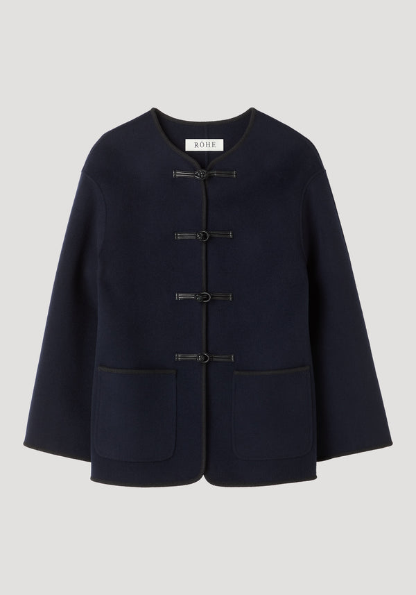 Mandarin double-faced wool jacket in navy with pankou closures, embroidered edges, and patch pockets, showcasing Róhe's signature style and craftsmanship.