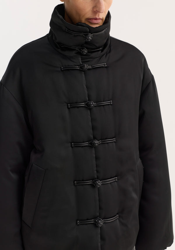 Padded puffer jacket | black with frog-toggle closures, high funnel collar, and slanted pockets, showcasing a stylish, water-repellent design.