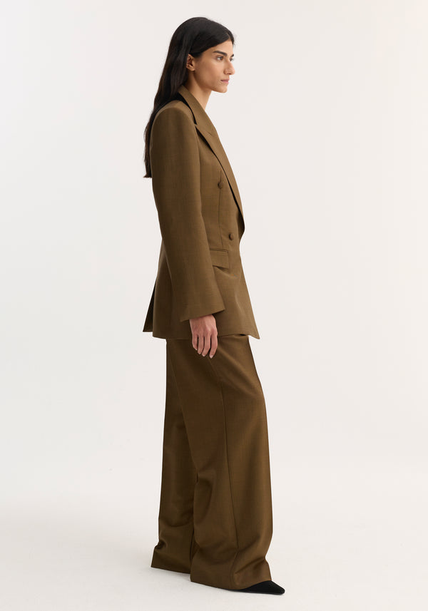 Double-breasted waisted blazer | golden brown, showcasing an hourglass silhouette with sharp notch lapels, strong shoulders, and a cinched waist.