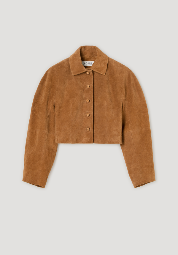 Rounded textured suede jacket | cognac features a cropped, button-front design with a minimalist fit, pointed collar, and tactile knotted leather buttons.